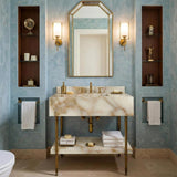 A luxury console vanity crafted from Calacatta Gold marble with brass legs and an integrated lower shelf.