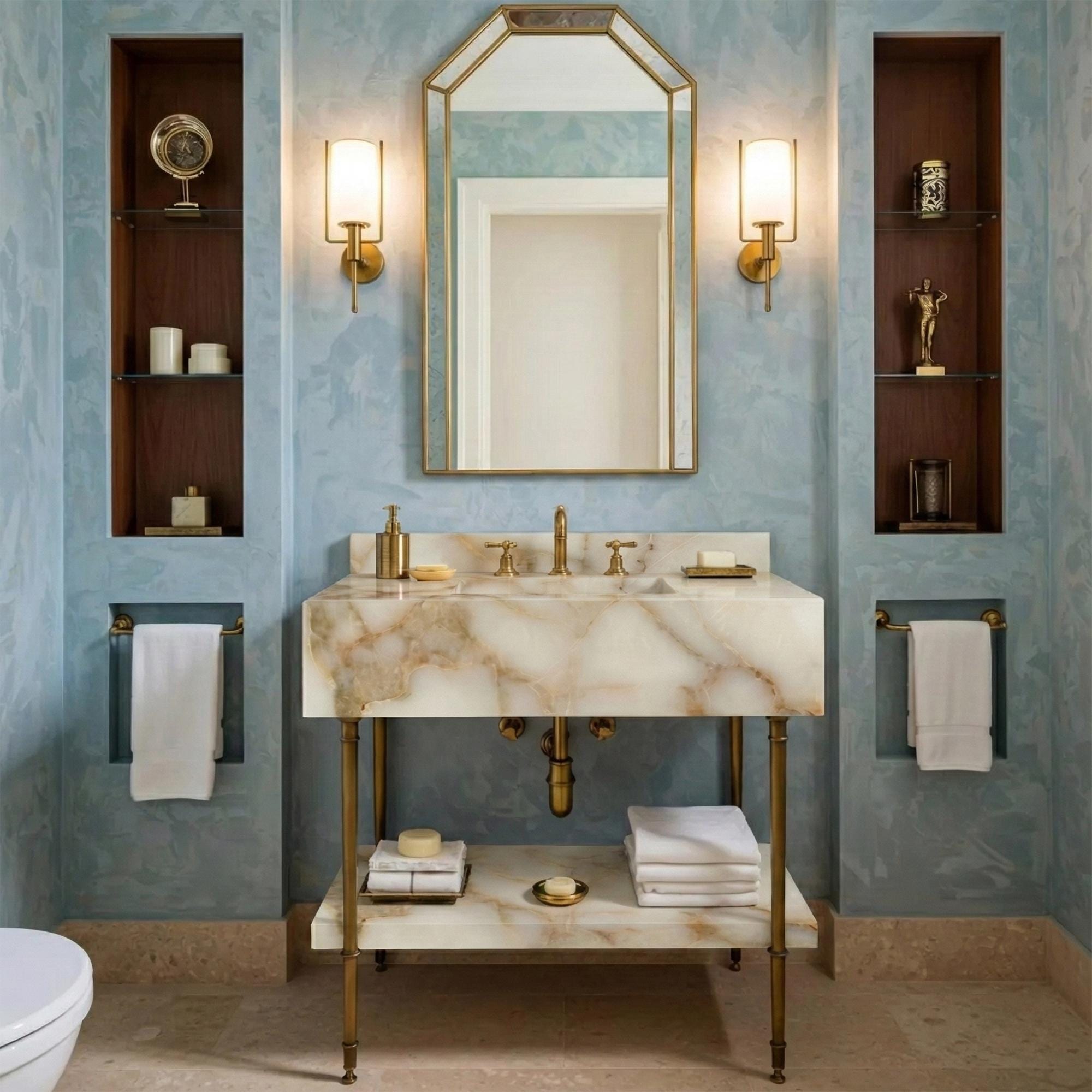 A luxury console vanity crafted from Calacatta Gold marble with brass legs and an integrated lower shelf.