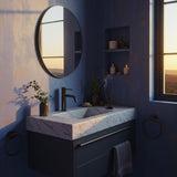 A Carrara marble floating sink with dark matte vanity, styled with incense and minimalist accessories in a luxury bathroom.