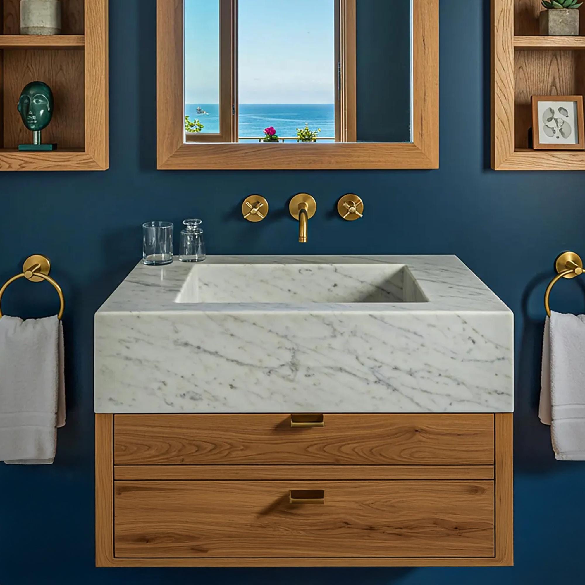 A square Carrara marble sink with integrated basin sits atop a walnut floating vanity.