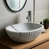 Refined bathroom sink with deep bowl, marble veining, and premium craftsmanship.