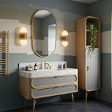 A luxurious curved bathroom vanity with Carrara marble top and double rattan-front drawers in a soft, modern interior.
