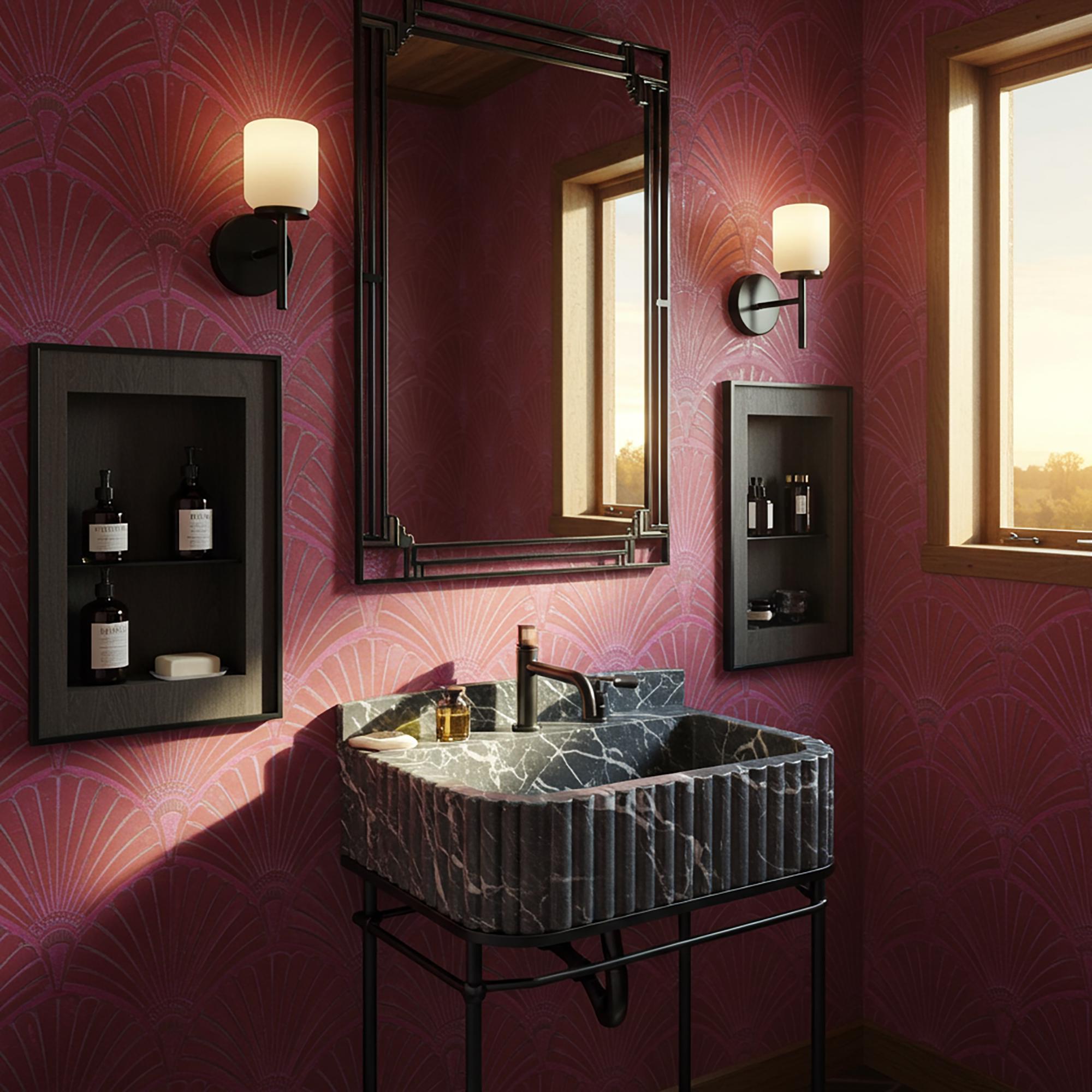 Dark sculpted marble basin paired with matte black fixtures in a modern bathroom setting.