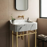 This fluted Carrara marble sink brings sculptural elegance and luxury to a modern wall-mounted bathroom vanity.