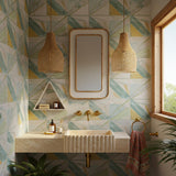 A wall-mounted travertine sink with a fluted apron front, styled in a colorful modern luxury bathroom.