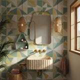 The fluted travertine wall-mounted sink adds sculptural charm to elegant, compact bathroom spaces.