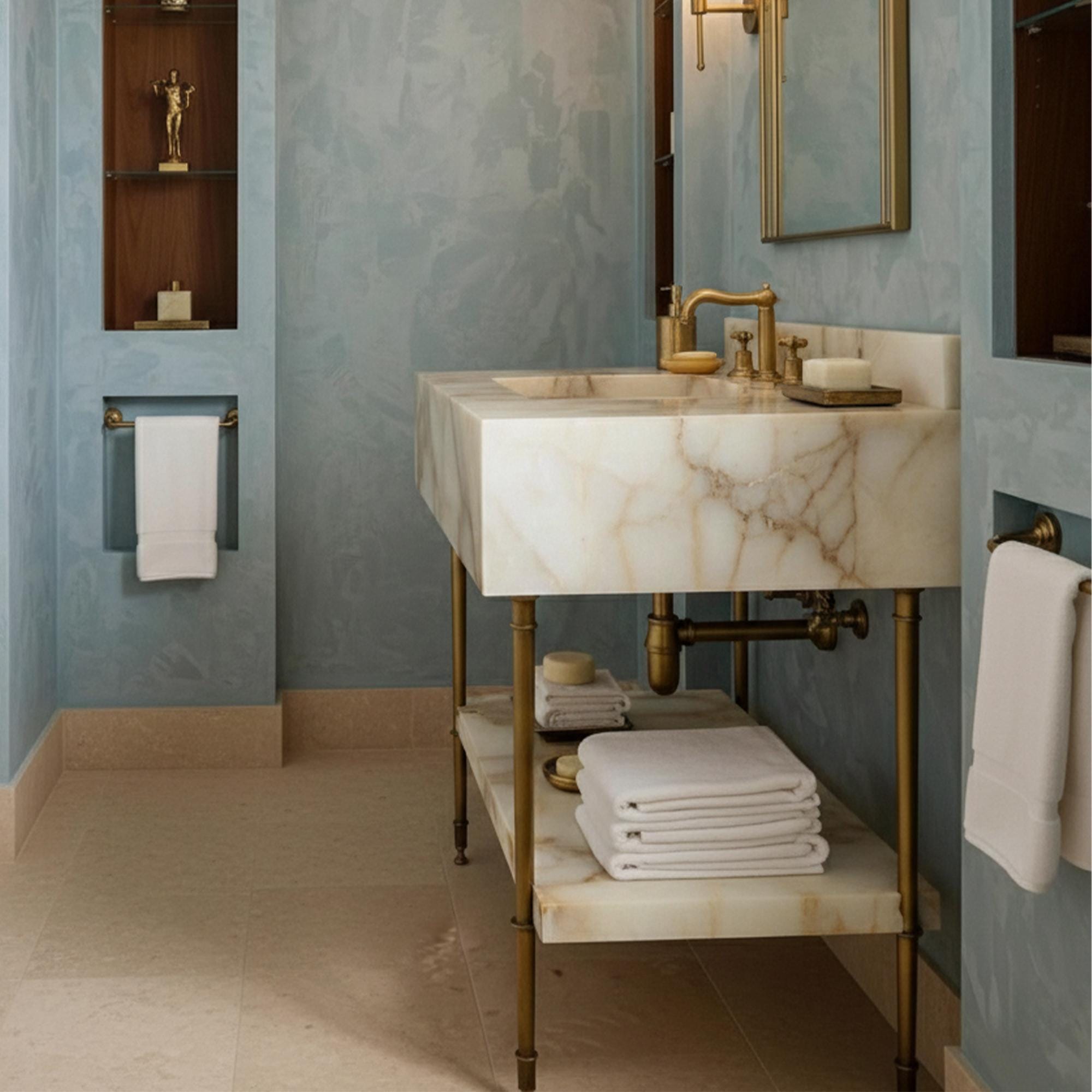Elegant bathroom sink with dramatic gold veining and an open brass structure beneath the marble slab.
