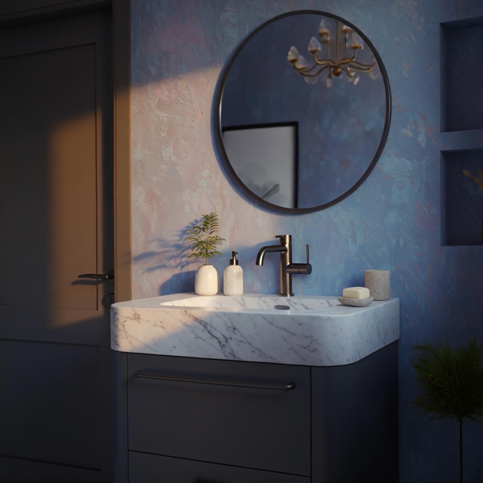 A luxurious Carrara marble sink sits atop a sleek black vanity cabinet, styled for contemporary bathrooms.